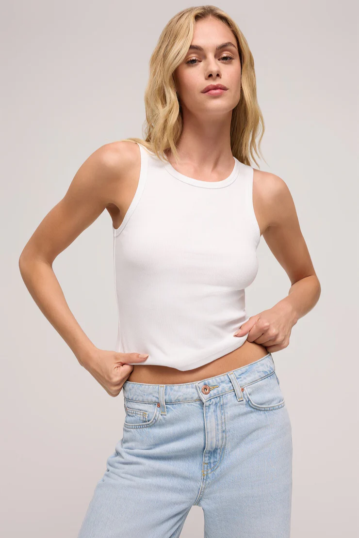 A woman wearing a black sleeveless tank top with a crew neck.