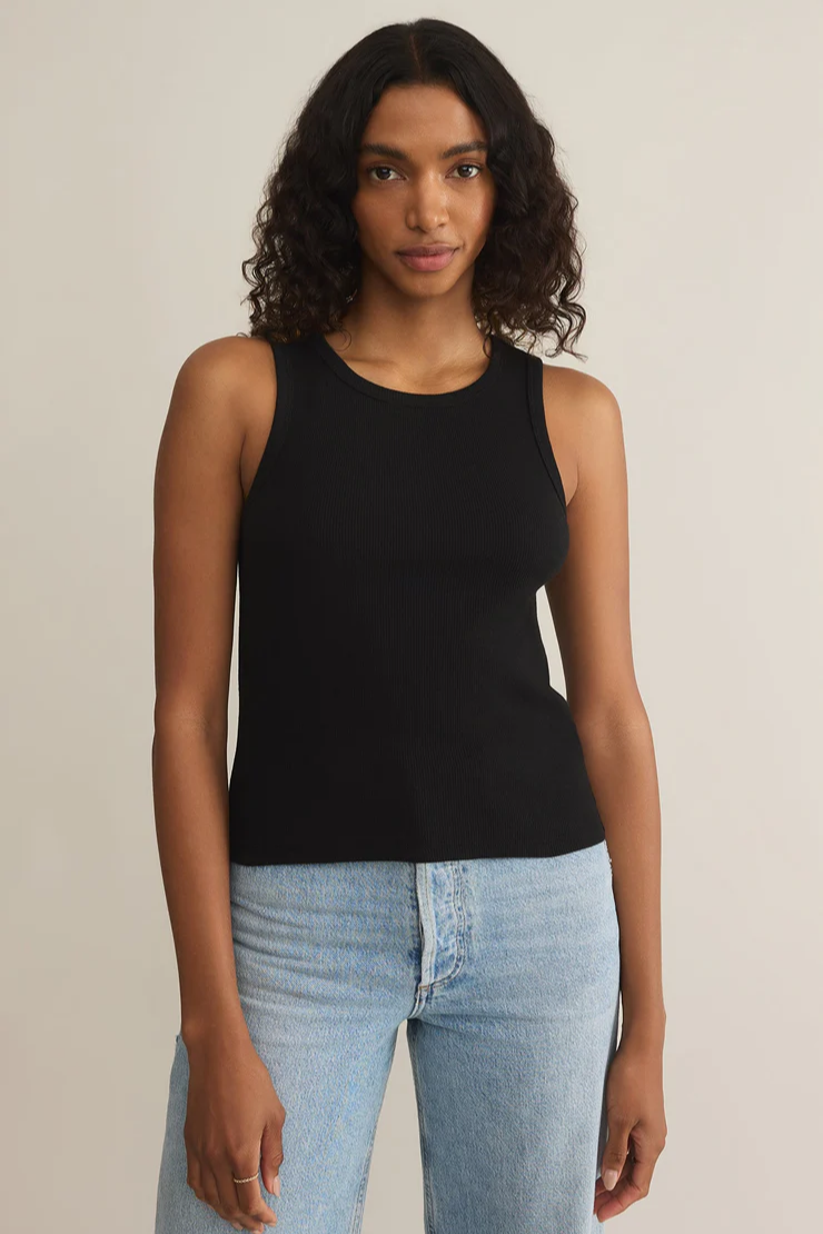 A woman wearing a black sleeveless tank top with a crew neck.