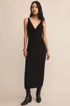 Woman wearing a black dress with a plain background