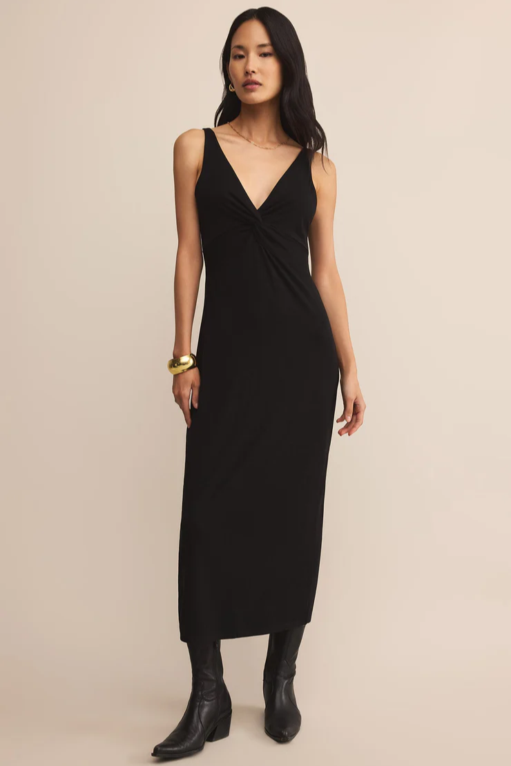 Woman wearing a black dress with a plain background