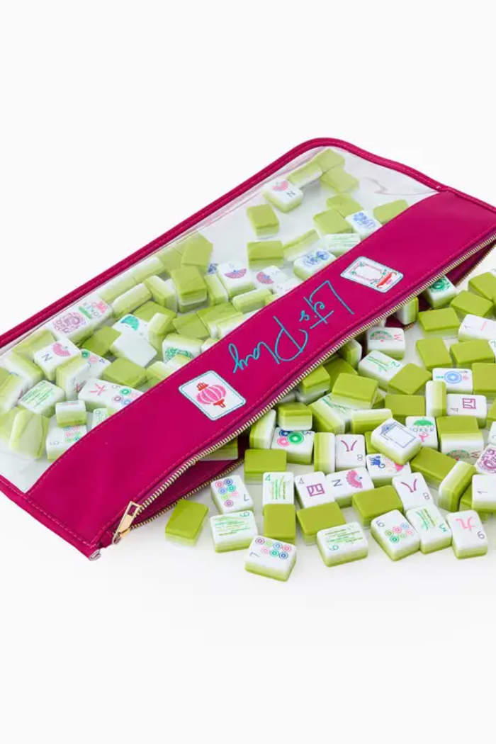 Green and white tiles with colorful symbols spilling out of a pink pouch labeled 'LEPA'.