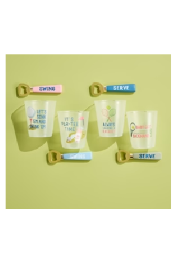 Set of four cups with decorative straws on a green background