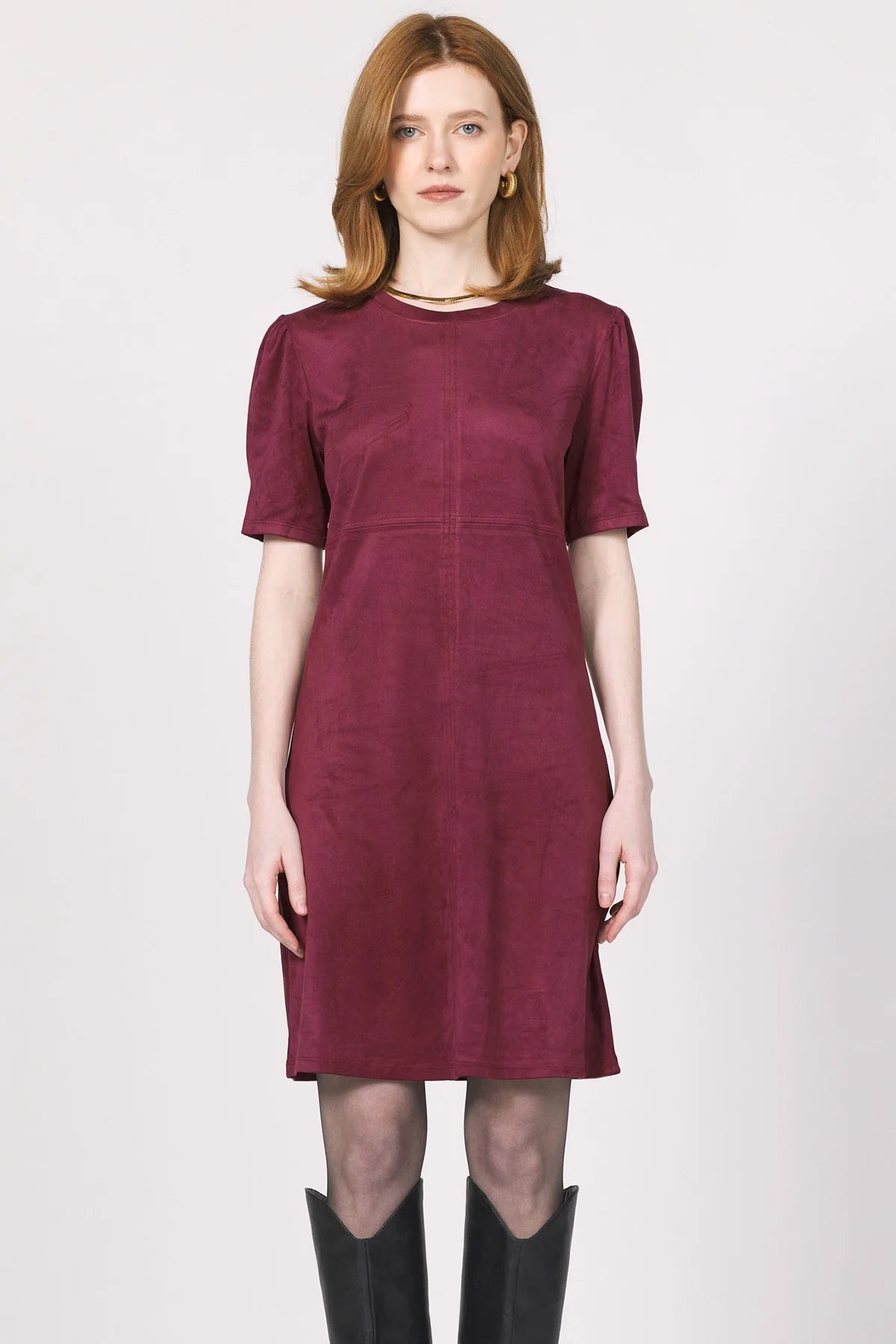 Woman wearing a burgundy dress on a white background