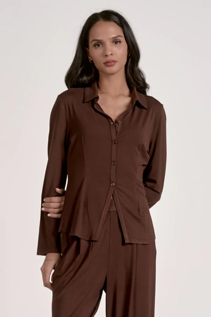 Woman wearing a brown outfit on a white background
