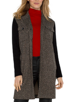 Woman wearing a brown tweed vest over a red turtleneck and black long-sleeve shirt on a white background