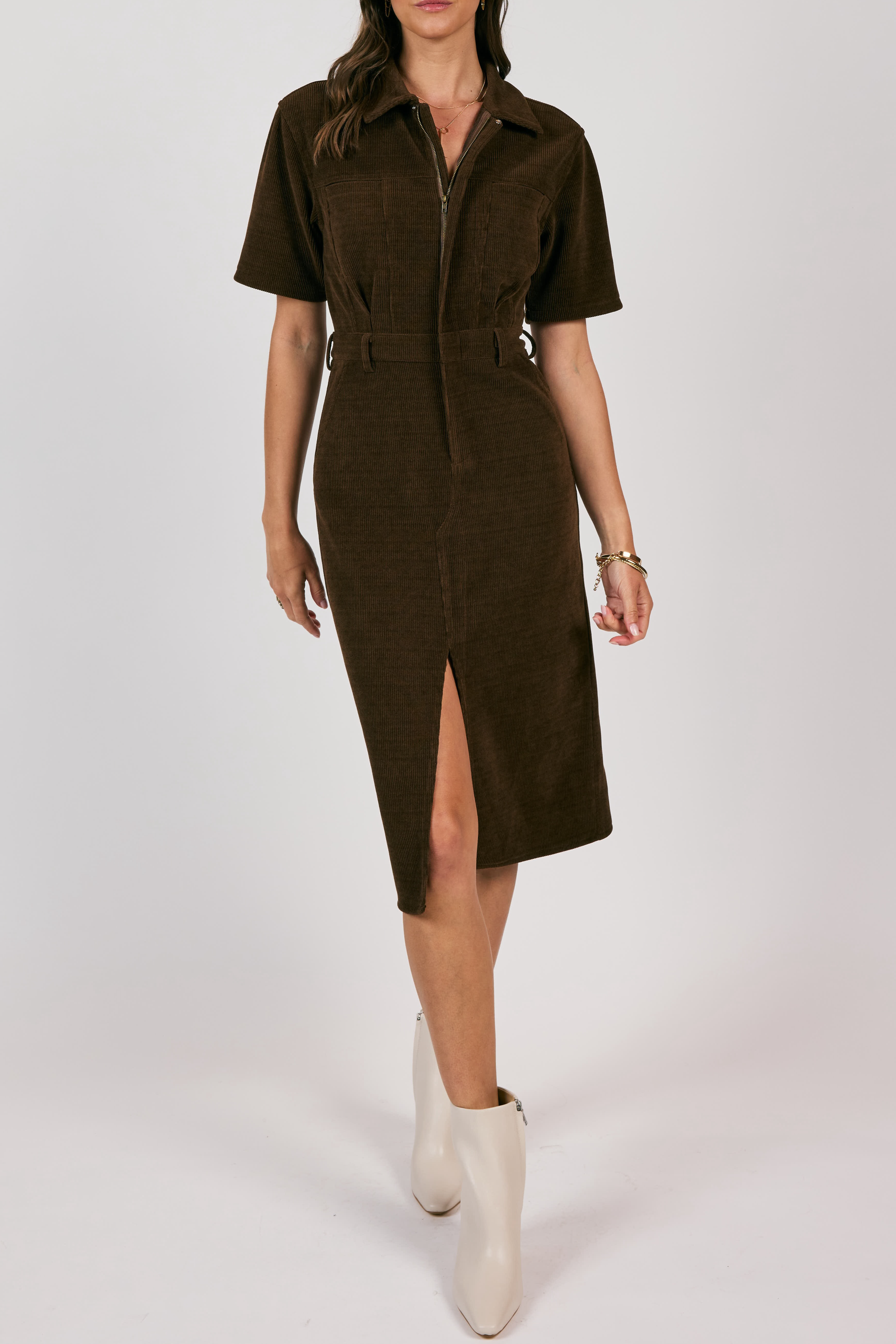 Brown dress with a belt worn by a person on a white background