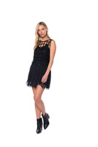 Woman wearing a black dress with cut-out details on a white background