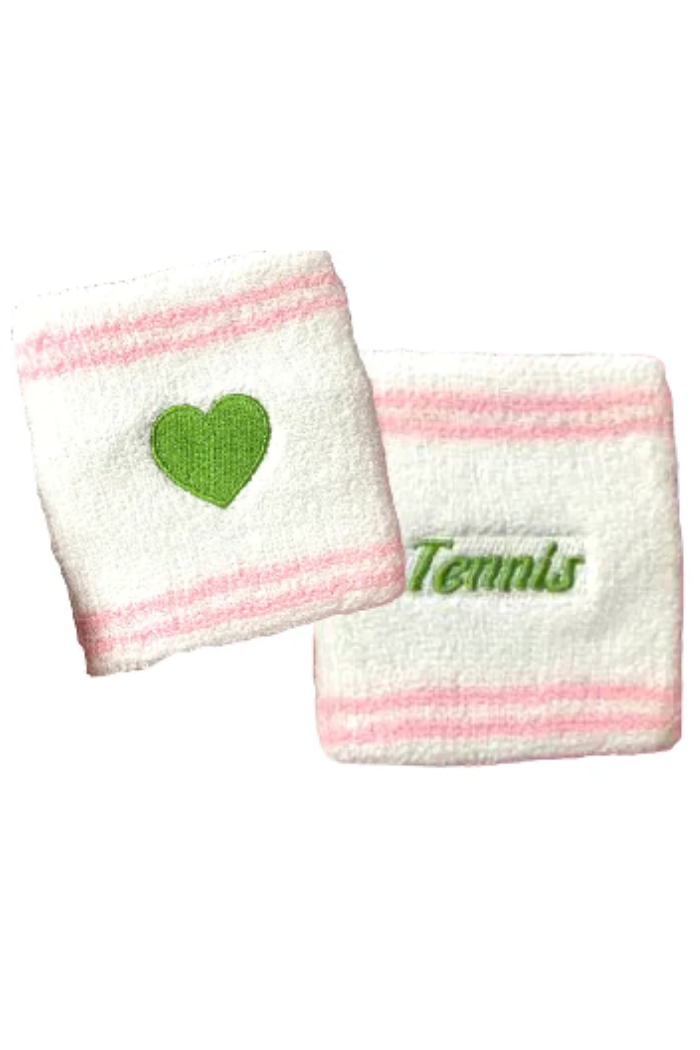 Two white sweatbands with pink stripes, one featuring a green heart and the other with 'Tennis' text, on a white background.