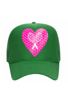 Green cap with a pink heart design featuring a tennis racket and white ribbon on a white background
