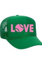 Green cap with pink 'LOVE' text and tennis ball graphic on a white background