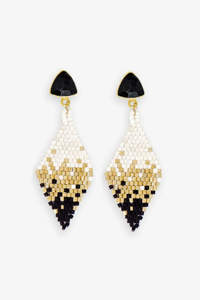 Pair of beaded earrings with black, gold, and white design on a white background