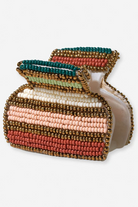 Multicolored beaded clutch bag on a white background