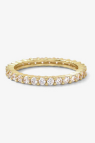 Gold ring with embedded diamonds on a white background