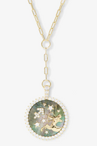 Necklace with a round pendant featuring a celestial design on a white background