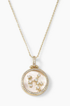Gold necklace with a pendant featuring a zodiac symbol on a white background
