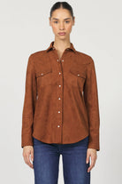 Woman wearing a brown suede shirt with a white background