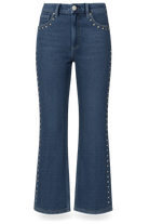 Blue jeans with studded details on a white background