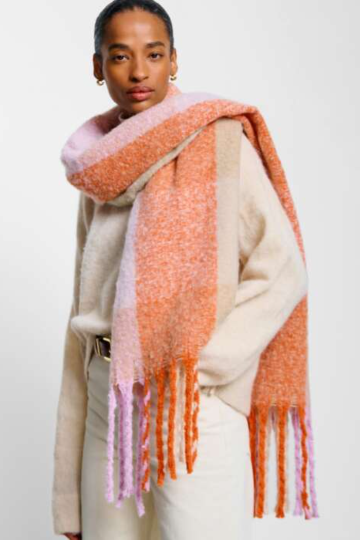 Woman wearing a colorful scarf with a white background