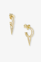 Gold spike earrings with clear stones on a white background