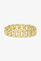 Gold chain-style ring on a white background