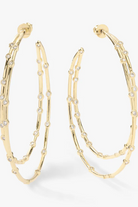 Gold hoop earrings with embedded stones on a white background