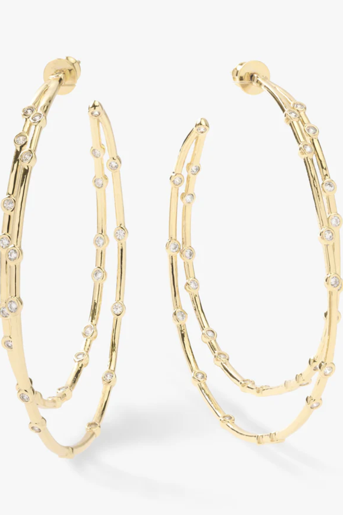 Gold hoop earrings with embedded stones on a white background
