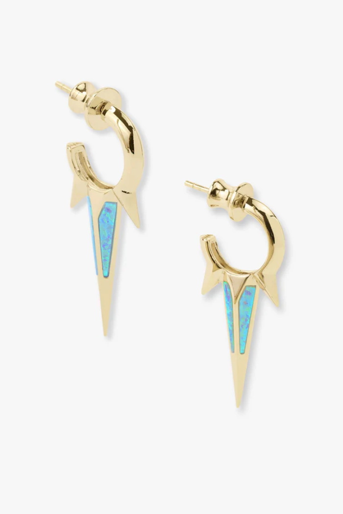 Gold and blue earrings on a white background