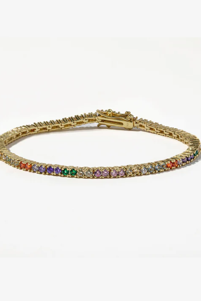 Gold bracelet with colorful gemstones on a white background