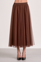 Brown tulle skirt worn by a person on a white background