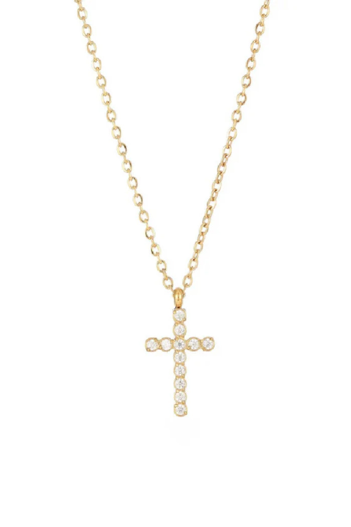 Gold cross necklace with clear stones on a white background