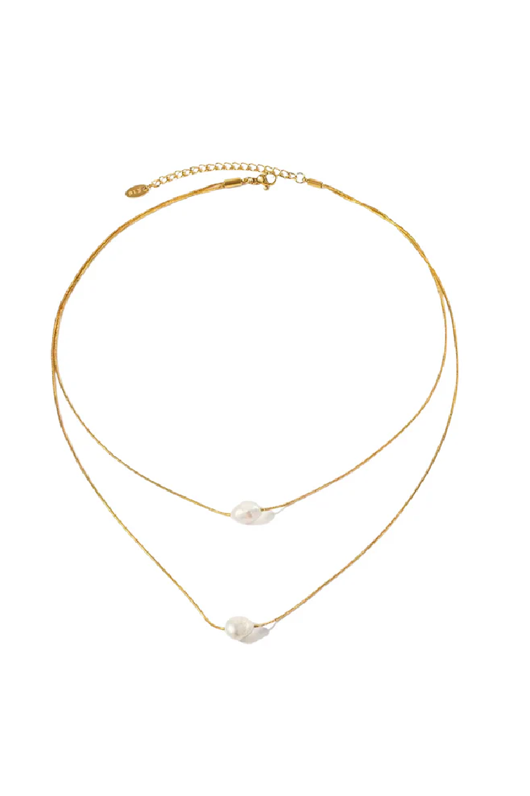 Gold necklace with pearl pendants on a white background