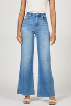 Person wearing light blue flared jeans on a white background