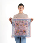 Woman holding open Florentine Bandana in peach pink and blue floral print