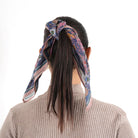 Florentine Bandana in peach blue tied around dark ponytail, back view