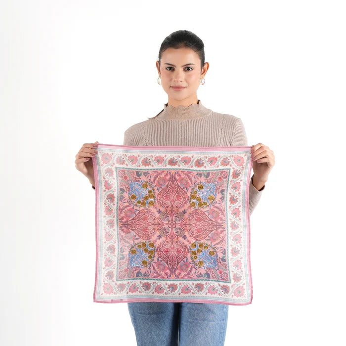Woman holding unfolded pink floral Vismaya Florentine Bandana against white background