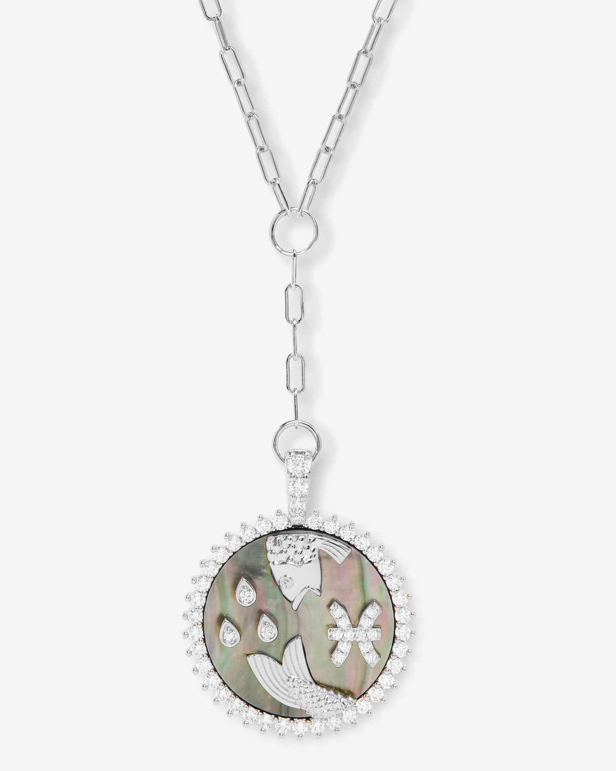 Silver Pisces zodiac medallion necklace with black mother-of-pearl and diamond halo, flat lay